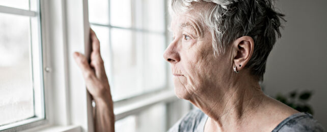 woman staring out a window