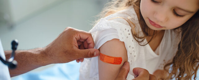 girl with sticking plaster on her arm