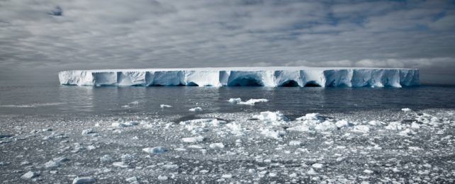 Ice melting and dark gloomy looking sea and sky