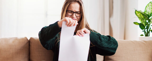 person tearing up paper